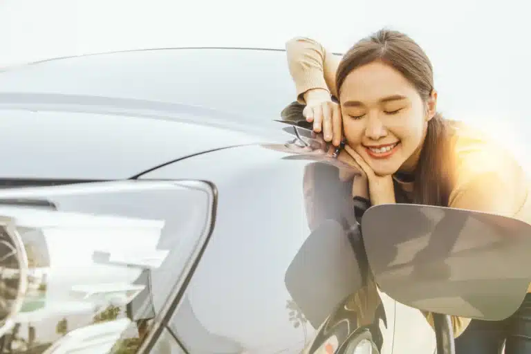 Happy woman using electric car leasing - Velocity Leasing