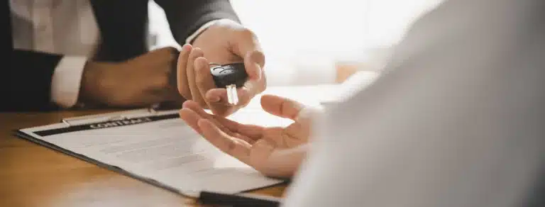 Hand holding keys to a leased electric car - Velocity Leasing