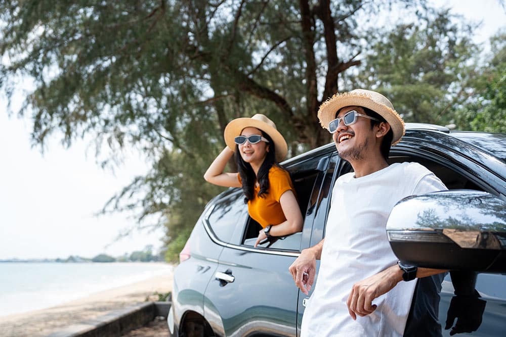Couple using rented electric car for vacation